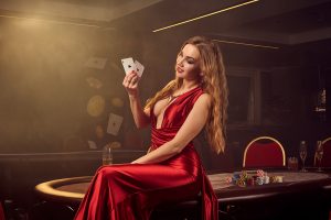 girl in red dress on poker table with cards